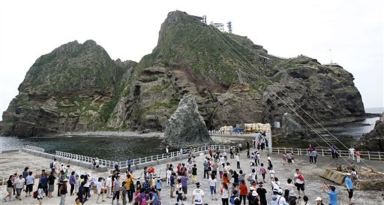 South Korean tourists visit Seodo, part of the disputed Dokdo islets, in the East Sea, South Korea, on Monday. South Korea banned three Japanese lawmakers from entering the country after they arrived at a Seoul airport in an attempt to travel near the islands.